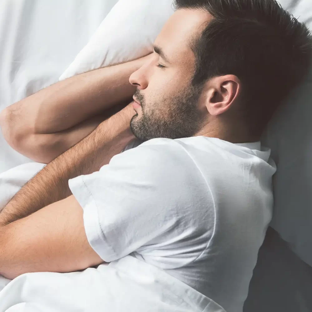 Uomo che dorme serenamente a letto.